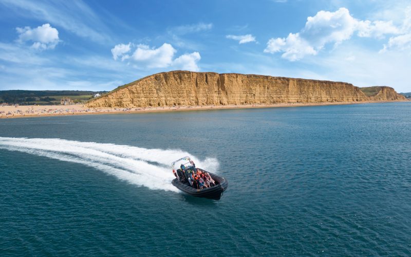 RIB boat cruising from West Bay Harbour on sunny day